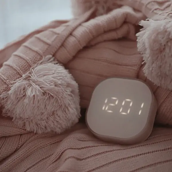 The minimalist alarm clock seamlessly blending with a stylish bedside decor.